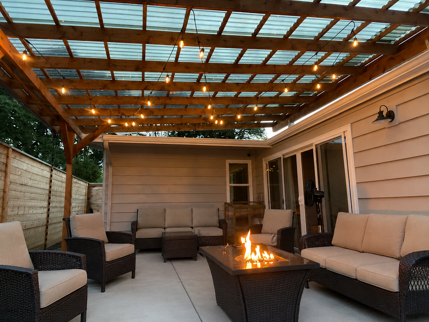 Completed covered patio with pergola, seating, and fire pit